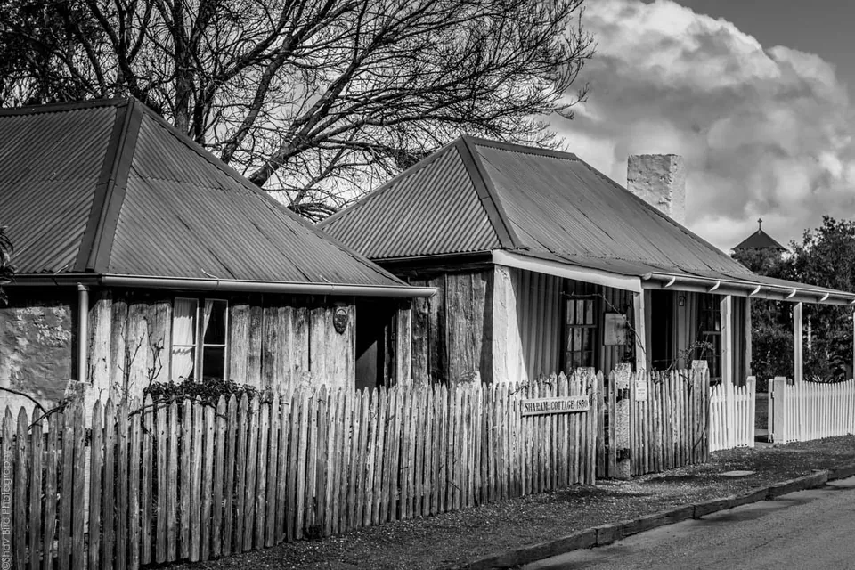 Historic slab cottages and picket fence in Penola
